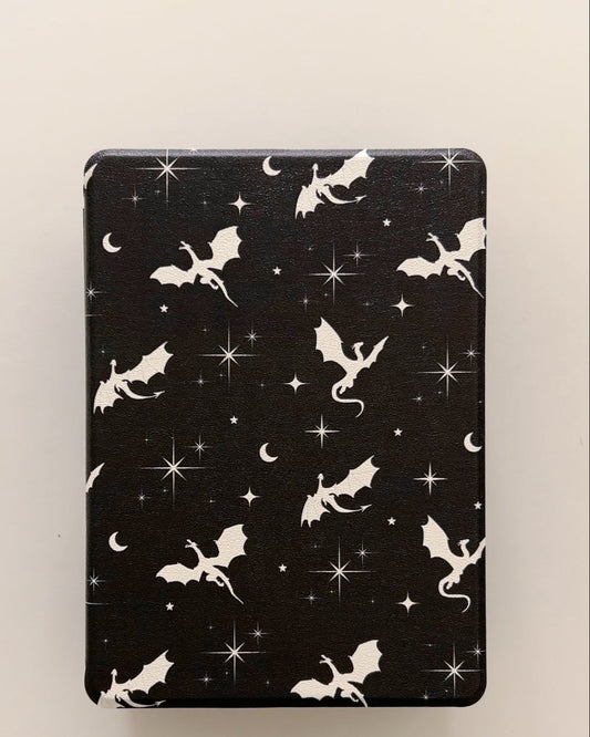 Black Kindle & Kobo case with white dragon and star pattern on a beige background